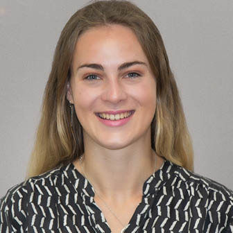 A woman wearing a black and white shirt. Description generated by AI