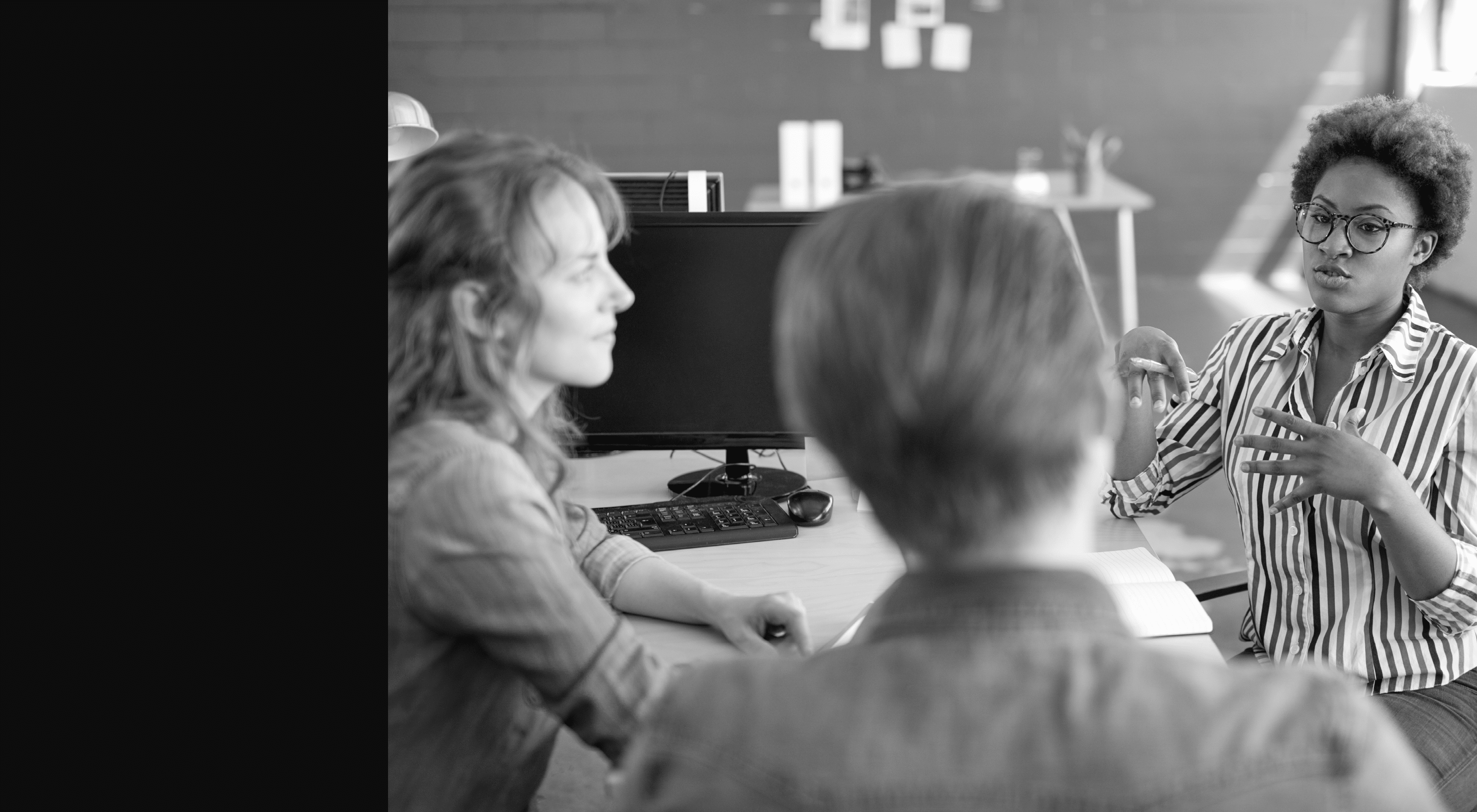 Candid picture of a business team collaborating. Filtered serie with light flares and cool tones.